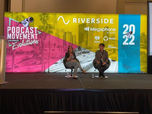 Two speakers on stage at Podcast Movement Evolutions in Los Angeles